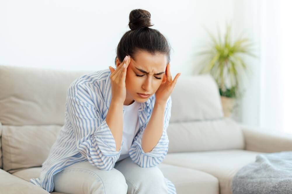 Stress,,Headache,,Illness.,Upset,Mixed,Race,Woman,Sitting,On,A