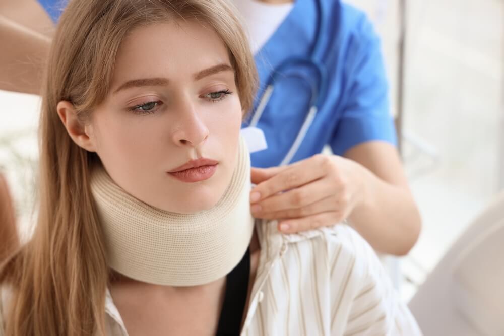 Injured,Young,Woman,After,Accident,With,Cervical,Collar,Visiting,Doctor